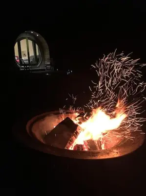 a cake on a table with a fire in it at Ty Barcud Glamping Pod in Aberystwyth