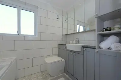 a white bathroom with a toilet and a sink at MODERN 3 BEDROOM PROPERTY WITH FREE DRIVEWAY PARKING by SHIRE STAYS in Shrewsbury