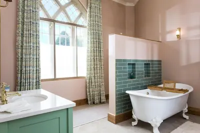 a bathroom with a tub and a sink at Bryngwilla Gate Lodge in Oswestry