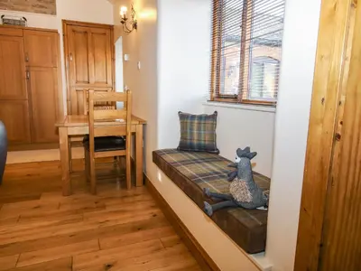 a small living room with a chair and a table at The Cart House in Shrewsbury