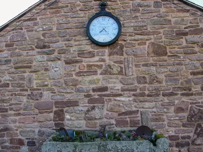a clock on the side of a brick wall at The Cart House in Shrewsbury