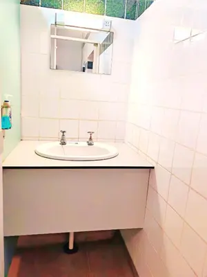 a bathroom with a sink and a mirror at Bunkhouse Accommodation in the Heart of Snowdonia in Dolgellau
