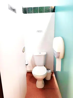 a bathroom with a white toilet in a stall at Bunkhouse Accommodation in the Heart of Snowdonia in Dolgellau