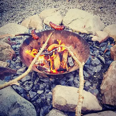 a fire in a pot sitting on some rocks at Bunkhouse Accommodation in the Heart of Snowdonia in Dolgellau