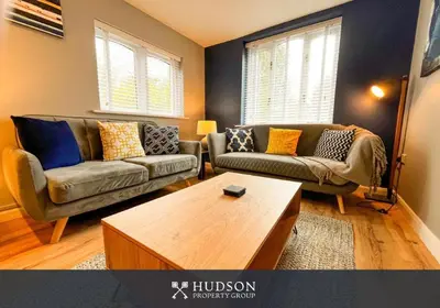 a living room with two couches and a coffee table at 2 Bedroom Home near Theatre Severn with Parking in Shrewsbury