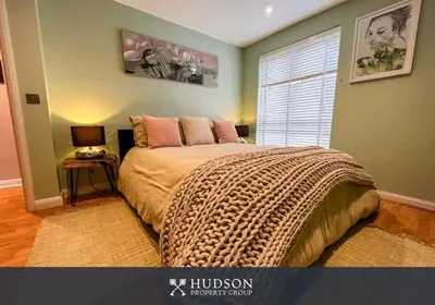 a bedroom with a large bed and a window at 2 Bedroom Home near Theatre Severn with Parking in Shrewsbury