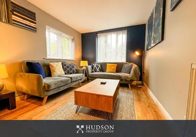 a living room with two couches and a coffee table at 2 Bedroom Home near Theatre Severn with Parking in Shrewsbury