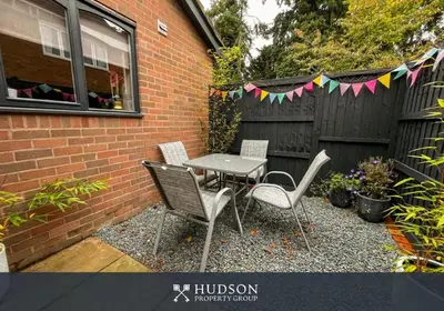 a patio with a table and chairs and a fence at 2 Bedroom Home near Theatre Severn with Parking in Shrewsbury