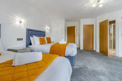 a hotel room with two beds with orange and white at 4 Bed in Capel Bangor oc-m30145 in Capel Bangor
