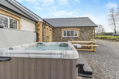 a hot tub in front of a house at 4 Bed in Capel Bangor oc-m30145 in Capel Bangor