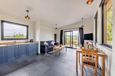 a kitchen and living room with a couch and a table at 1 Bed in Llanerfyl oc-d30168 in Llanfair Caereinion