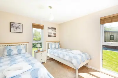 a bedroom with two beds and a window at Ash Lodge in Craven Arms