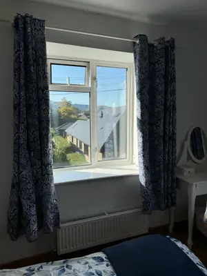 a bedroom window with a view of a house at 3 bedroom cottage Brecon sleeps 4 in Brecon