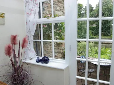 an open window with a window sill with a plant at Troutbeck Cottage in Ludlow