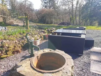 a water fountain in a garden with a sink at Craig Fach Coach House in Builth Wells