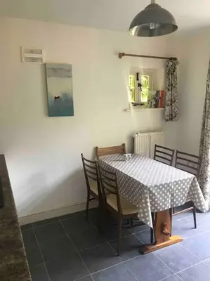 a dining room with a table with chairs and a white table cloth at Craig Fach Coach House in Builth Wells