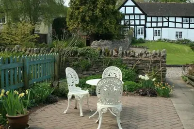 two chairs and a table in a garden at Peel Cottage, Dilwyn in Dilwyn