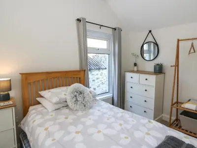 a bedroom with a bed and a window at Pengraig in Tregaron