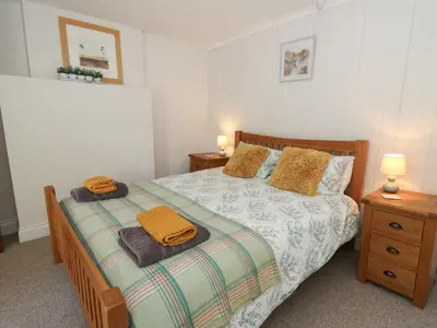 a bedroom with a bed with two towels on it at Pengraig in Tregaron