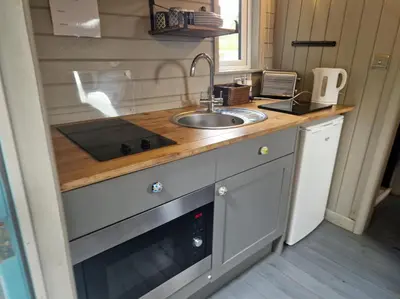 a small kitchen with a sink and a sink at Glan yr Afon Dau - Relax Recuperate Hot Tub in Welshpool