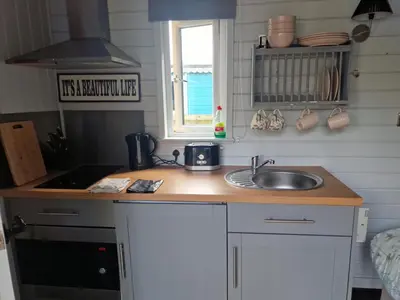 a small kitchen with a sink and a window at Glan yr Afon Un - Relax Recuperate Enjoy in Welshpool