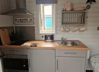 a small kitchen with a sink and a window at Glan yr Afon Un - Relax Recuperate Enjoy in Welshpool