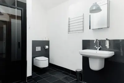 a white bathroom with a sink and a toilet at Finest Retreats - The Welsh Barn in Aberystwyth