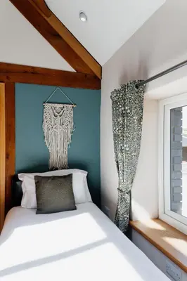 a bedroom with a bed and a window at Finest Retreats - The Welsh Barn in Aberystwyth