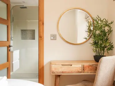 a bathroom with a wooden table and a mirror at White House in Montgomery