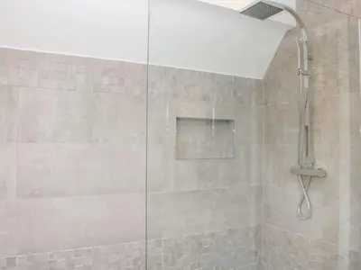a shower with a glass door in a bathroom at White House in Montgomery