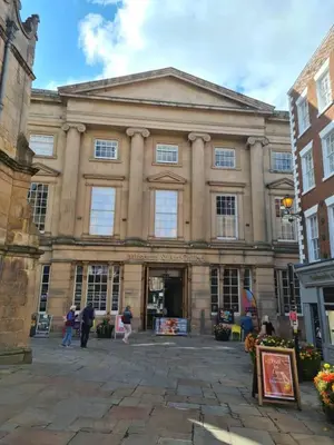 a large building with people standing outside of it at Cosy Studio - Town centre flat with free nearby parking in Shrewsbury