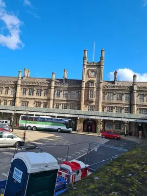a large building with a bus parked in front of it at Cosy Corner - Town centre flat with free nearby parking in Shrewsbury