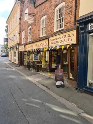 a street with shops on the side of a building at Cosy Corner - Town centre flat with free nearby parking in Shrewsbury