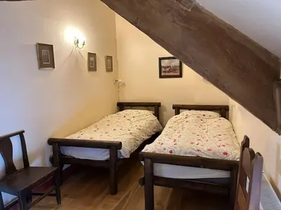 two twin beds in a room with a attic at Happy Horse Cottages in Sennybridge