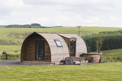 a small cabin in the middle of a field at Hafren by Wigwam Holidays in Llanbrynmair