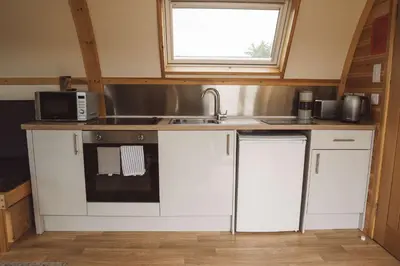 a kitchen with a sink and a microwave at Hafren by Wigwam Holidays in Llanbrynmair