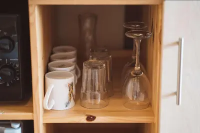 a shelf with glasses and other glass items on it at Hafren by Wigwam Holidays in Llanbrynmair