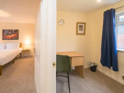 a bedroom with a desk and a bed and a window at 3 bedroom detached homesleeps 5 in Shrewsbury - Pass the Keys in Bicton