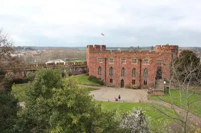 a large brick building with a flag on top at 3 bedroom detached homesleeps 5 in Shrewsbury - Pass the Keys in Bicton