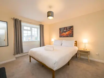 a bedroom with a large white bed and a window at 3 bedroom detached homesleeps 5 in Shrewsbury - Pass the Keys in Bicton