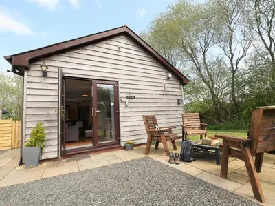 a small shed with a bench and a table at 2 Bed in Llandrindod Wells oc-88203 in Llandegley