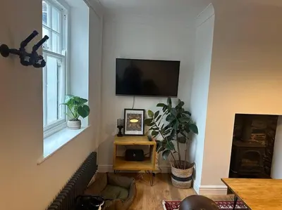 a living room with a couch and a flat screen tv at Charming newly renovated 3 bed cottage in Brecon town with private garden & pets welcome in Brecon