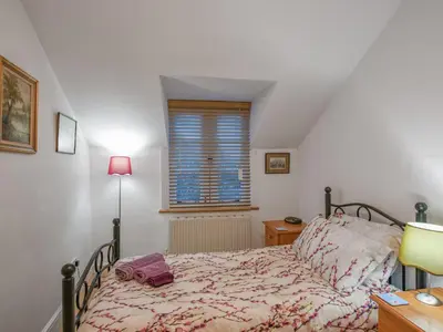 a bedroom with a bed and a window at Paul Pry in Ludlow