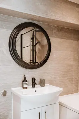 a bathroom with a sink and a mirror at 2 Bed Apartment Overlooking the Square Step Out to Shops & Dining in Shrewsbury