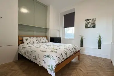 a bedroom with a bed and a window at Barmouth beach ground level in Barmouth