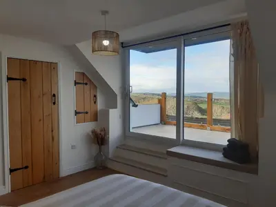 a bedroom with a large window with a view at Jasmine Cottage in Shrewsbury
