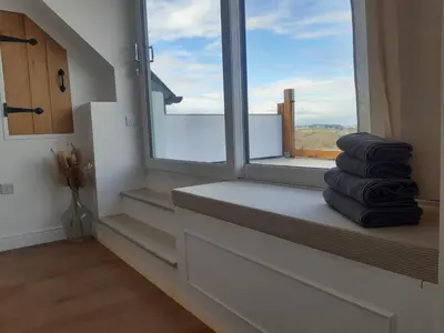 a stack of towels sitting on a window sill at Jasmine Cottage in Shrewsbury