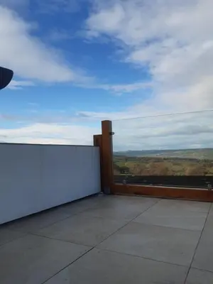 a balcony with a white wall and a view at Jasmine Cottage in Shrewsbury