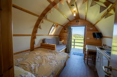 a bedroom with a bed in a room with a window at Knighton by Wigwam Holidays in Knighton