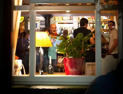 a man standing in a store window with a plant at Usk And Railway Inn in Sennybridge